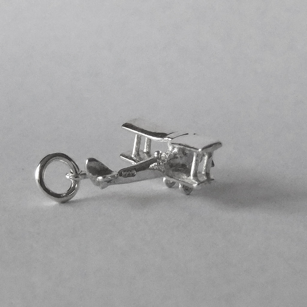 Tiger Moth aeroplane charm in sterling silver on a grey background