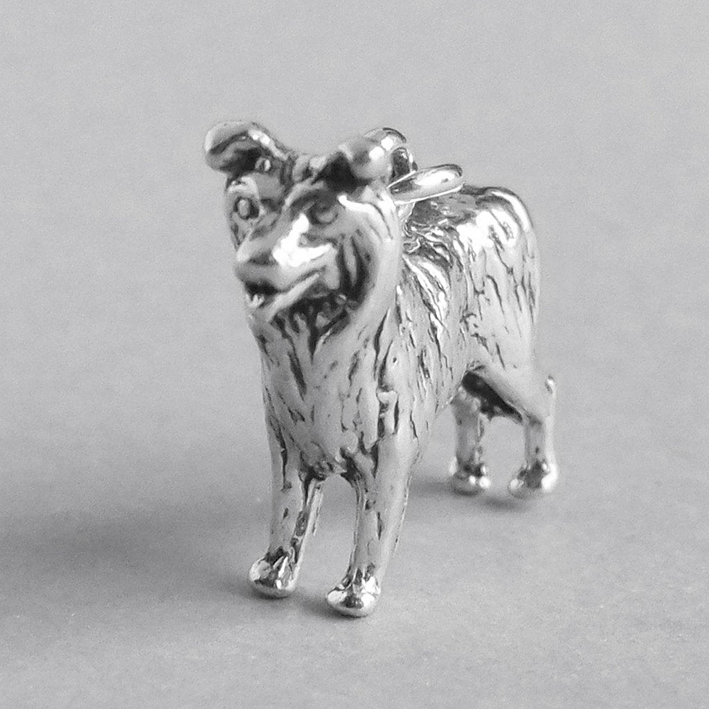 sterling silver border collie dog charm on a grey background
