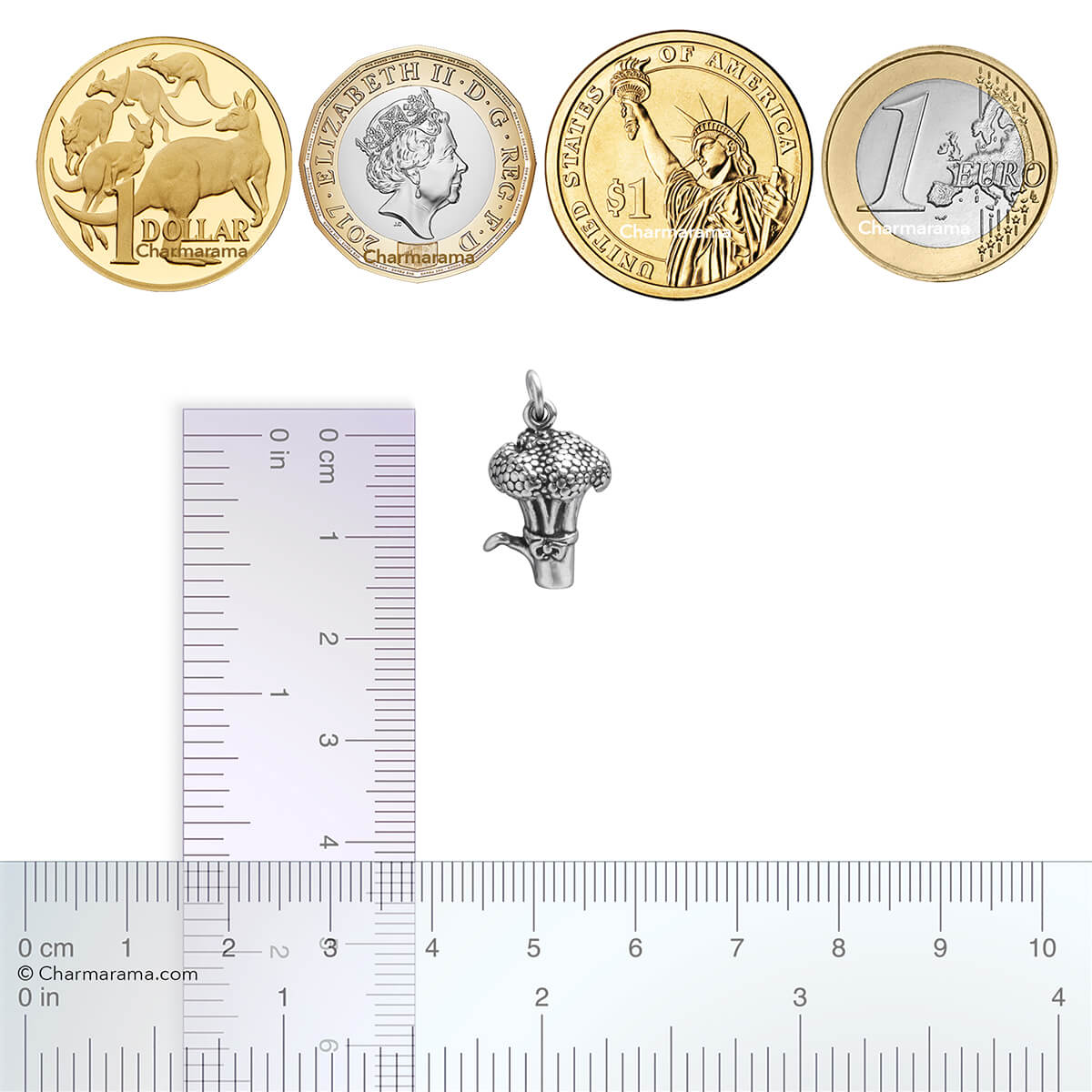 Sterling silver broccoli charm with ruler and coins for scale on white background