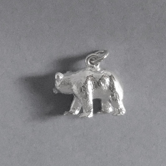 sterling silver bear charm on grey background