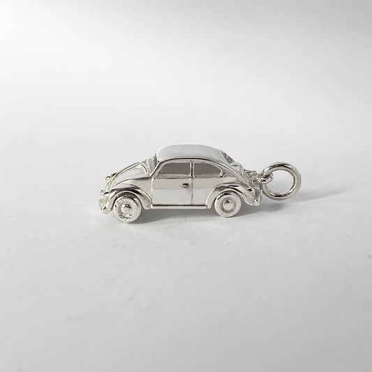 sterling silver beetle car pendant on grey background