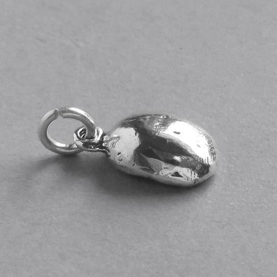 silver coffee bean charm from side on grey background