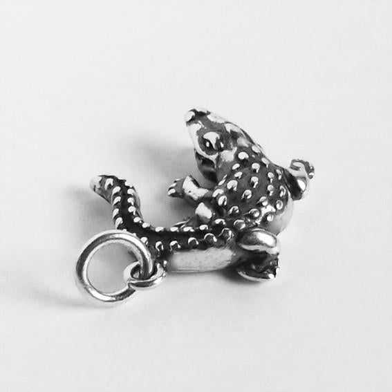 silver crocodile charm on light grey background