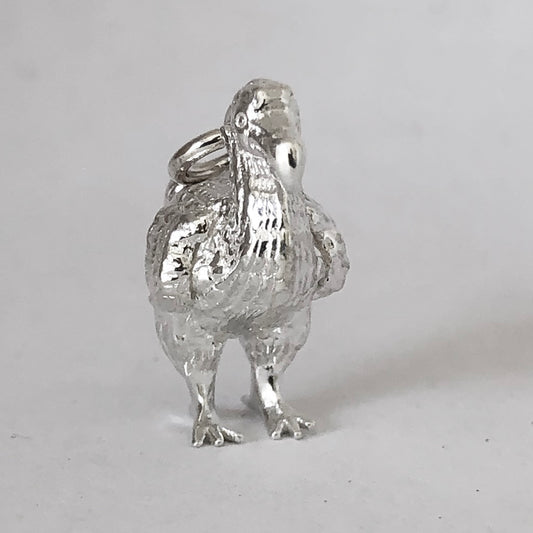 Sterling silver dodo charm on a white background