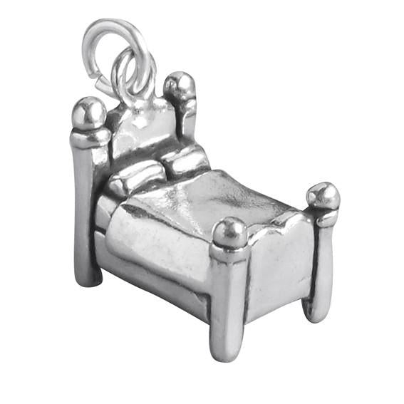 silver bed charm on white background