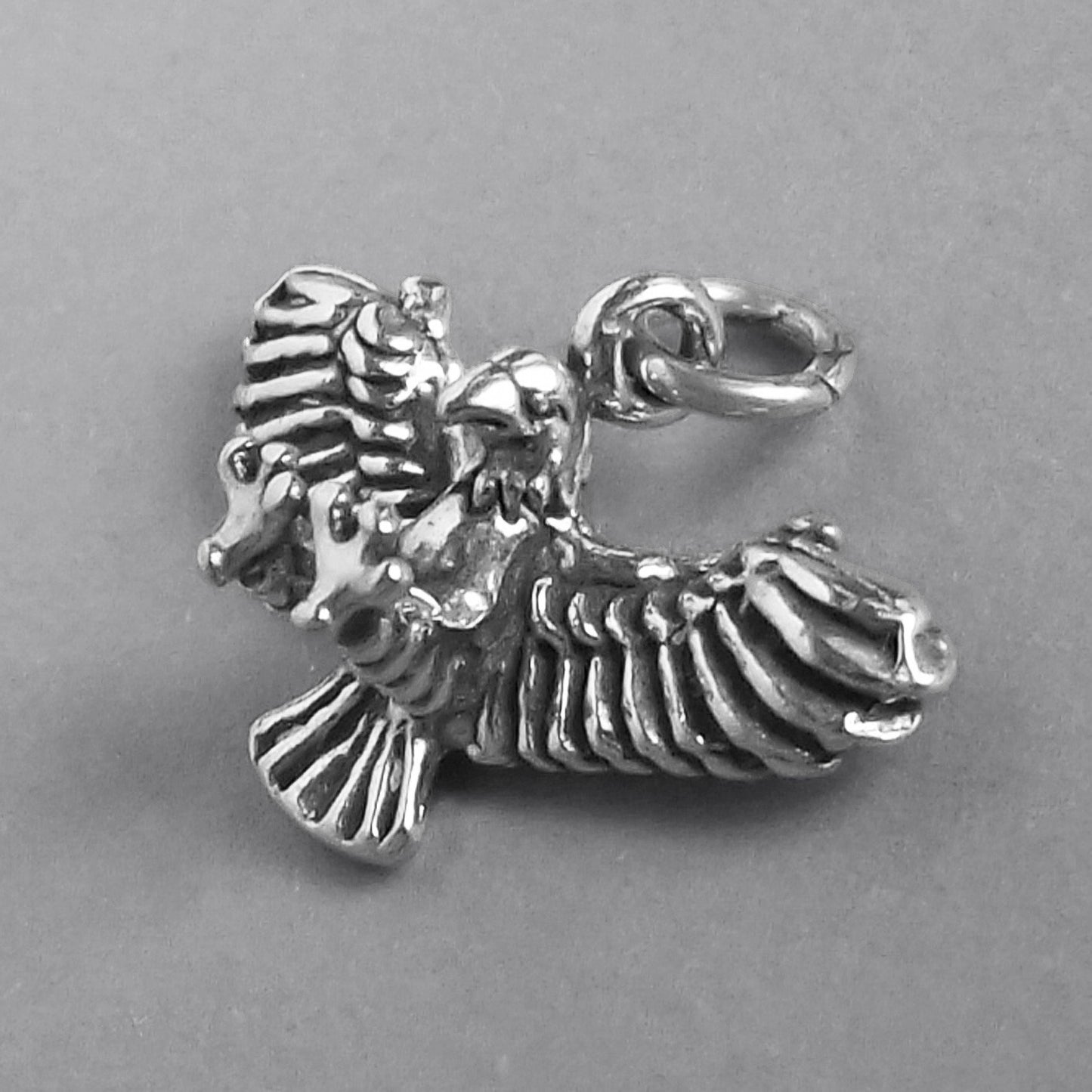 silver eagle charm side view on grey background
