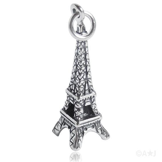 silver eiffel tower charm on white background