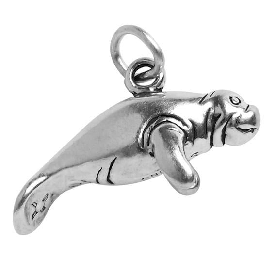 silver manatee charm on white background