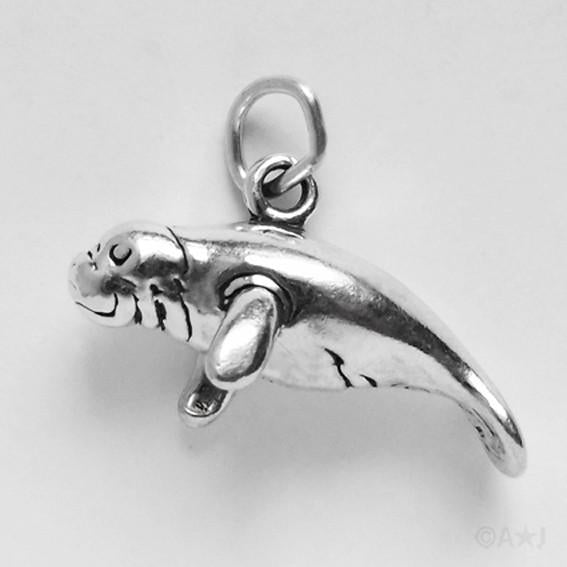 silver manatee or Dugong Charm on grey background