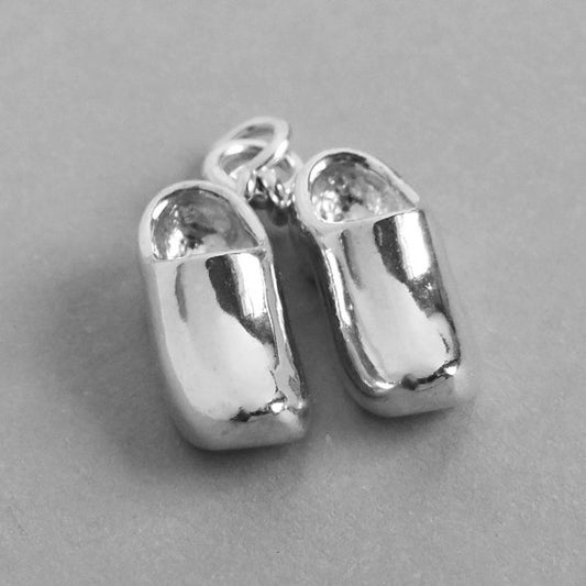 Sterling silver clogs charm on grey background