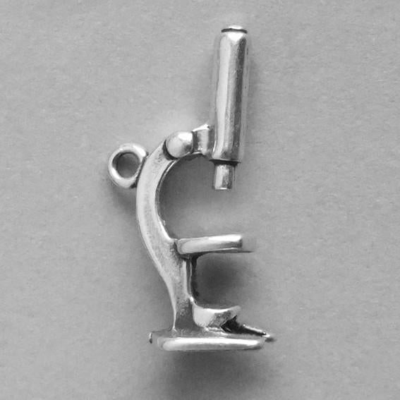 Silver 3D microscope charm on grey background