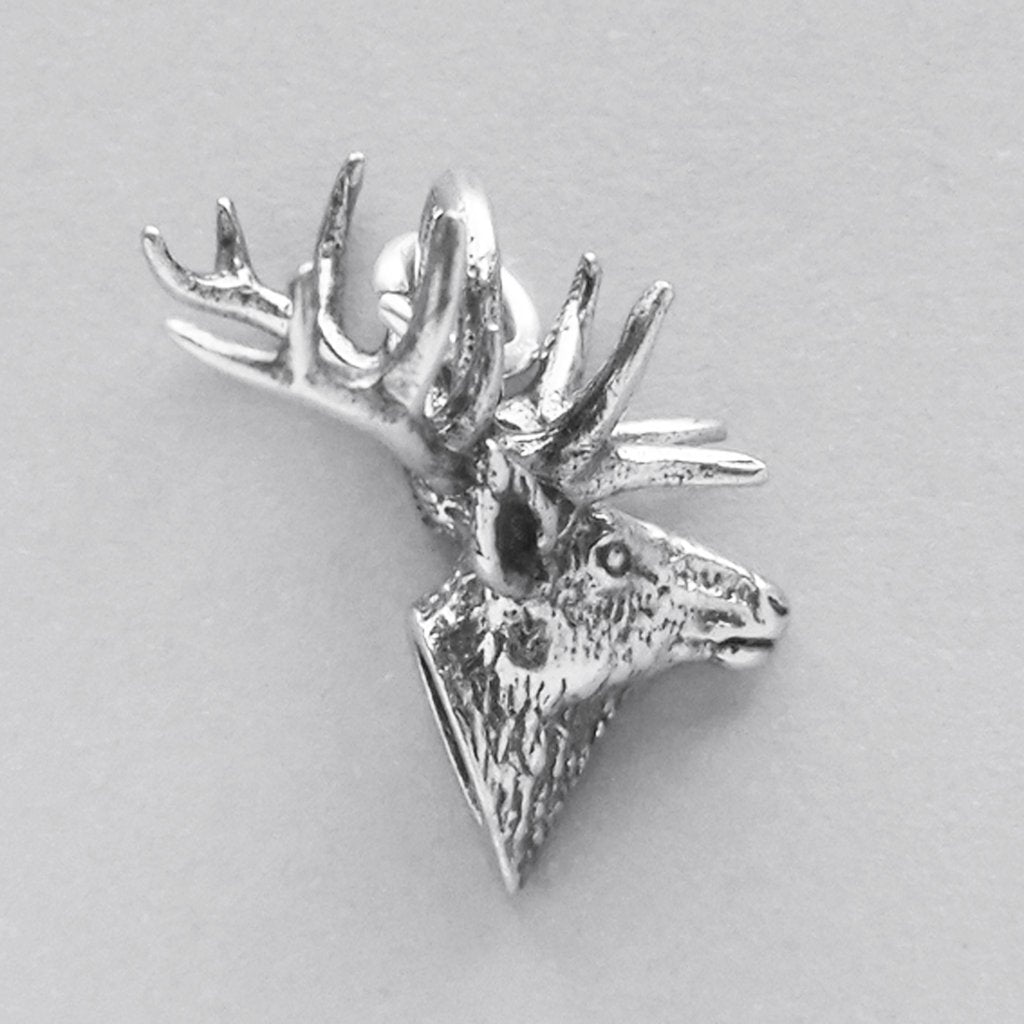 silver stag head charm side view on grey background