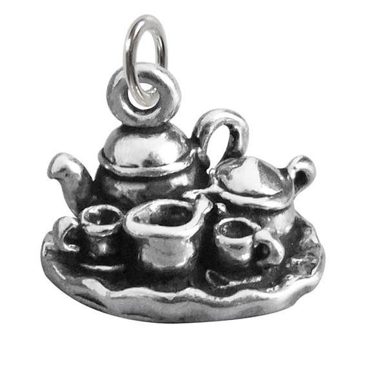 silver tea set charm on white background