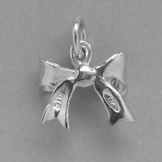 silver bow charm on a grey background