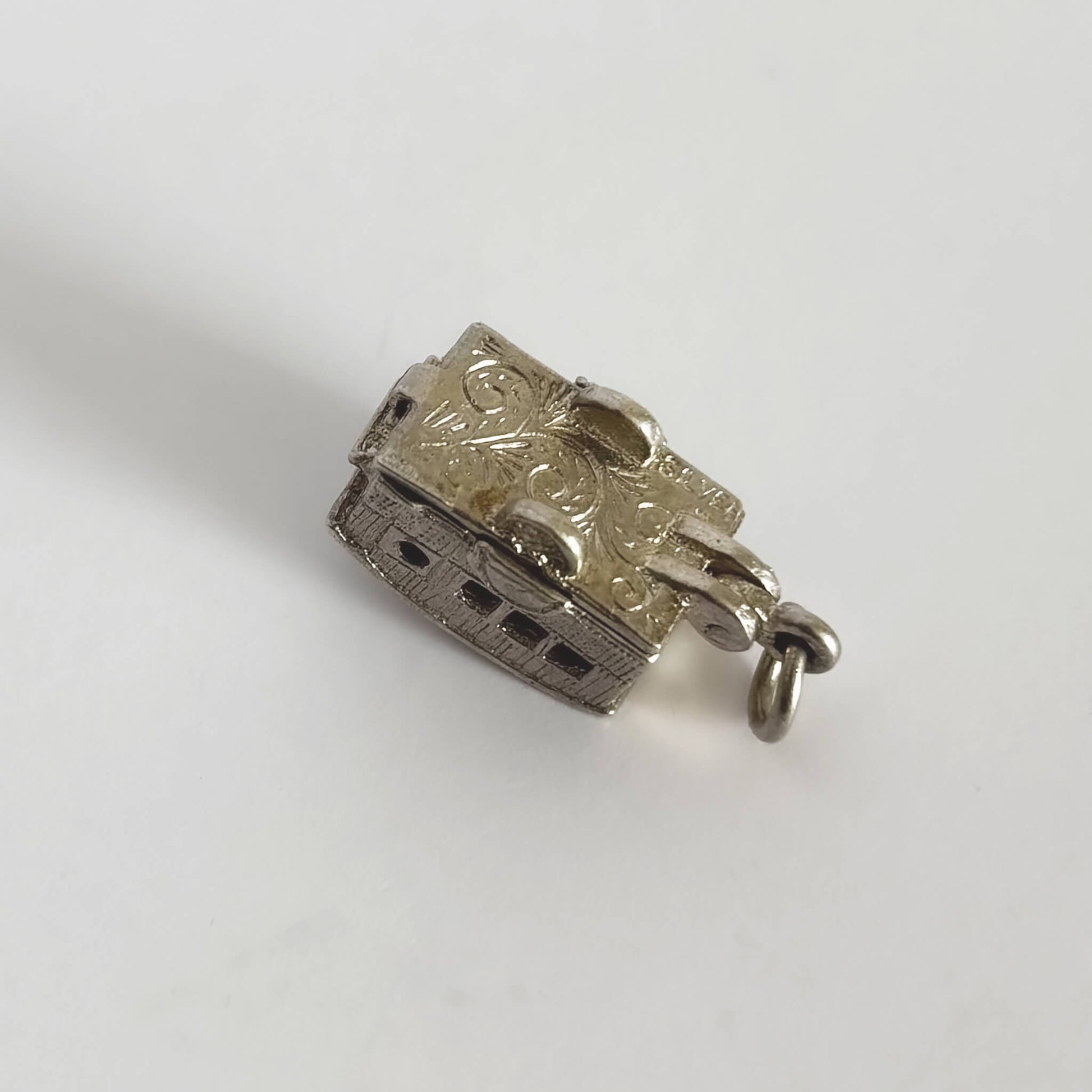 Caravan charm in silver opening to enamel interior