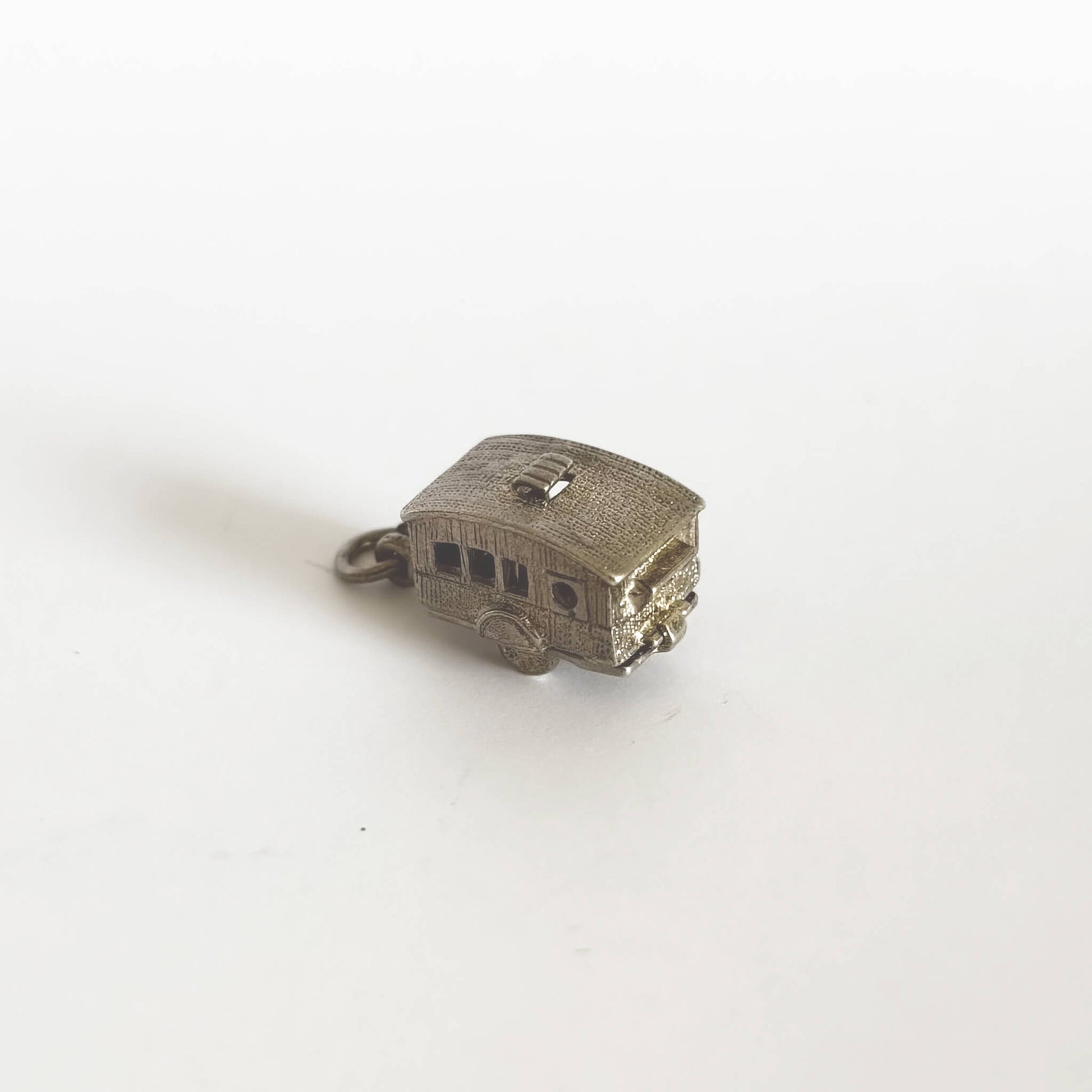 Caravan charm in silver opening to enamel interior