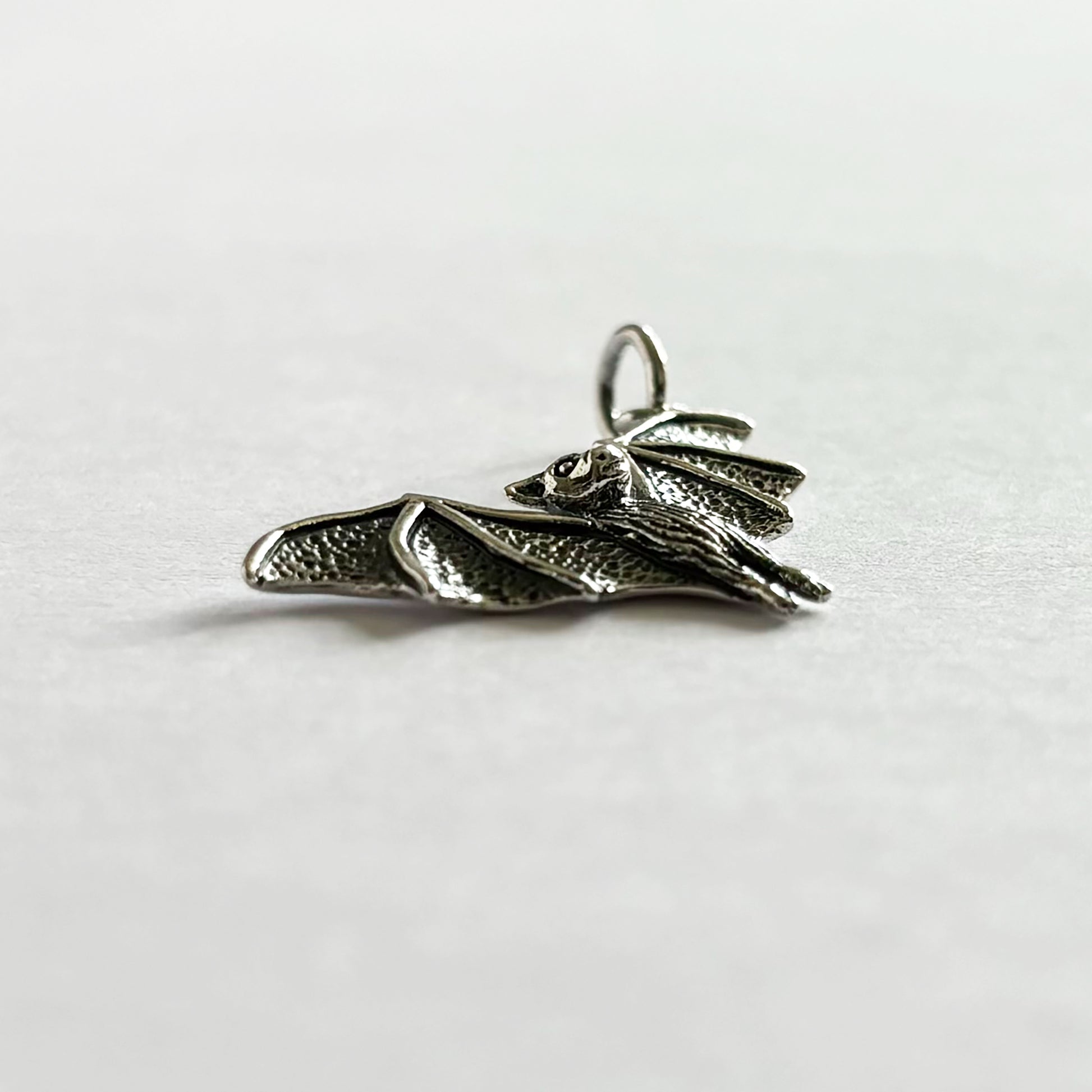 Side view of sterling silver bat charm from Charmarama