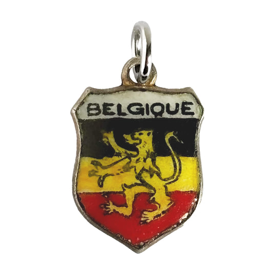 Vintage Belgium travel shield charm with black yellow and red enamel and rampant lion on white background.
