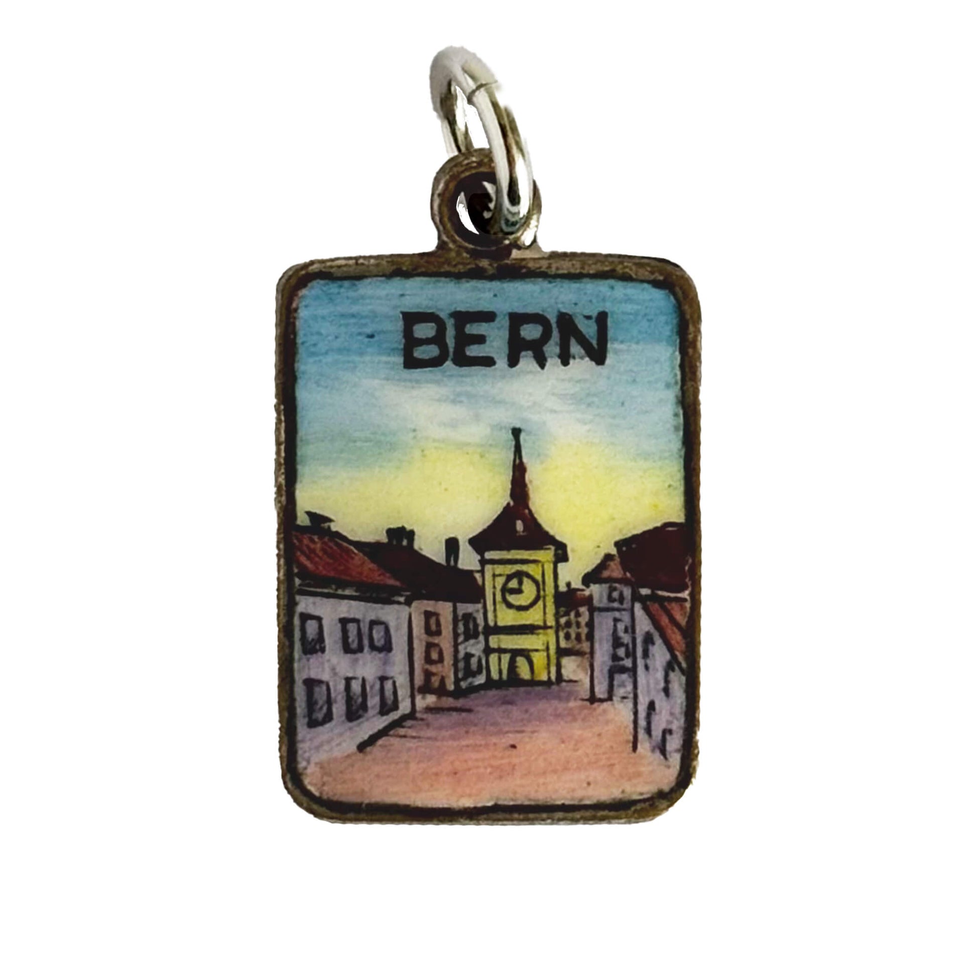 Pendant with a miniature painting of a street scene labeled 'Bern' on a white background