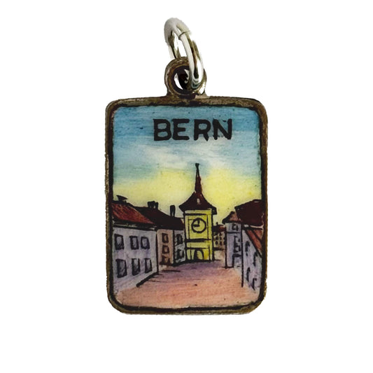 Pendant with a miniature painting of a street scene labeled 'Bern' on a white background