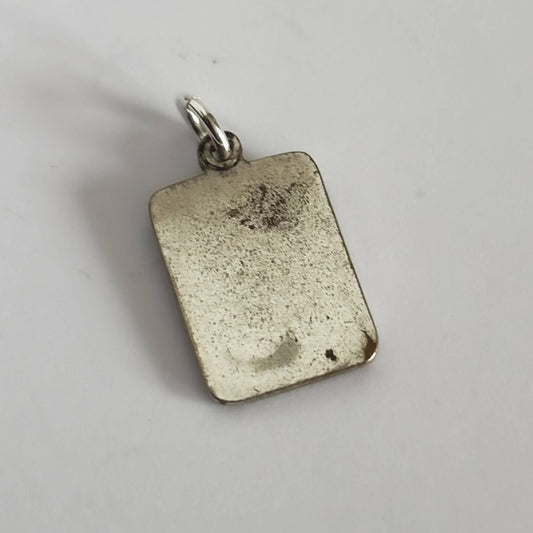 Silver rectangular pendant on a light gray background