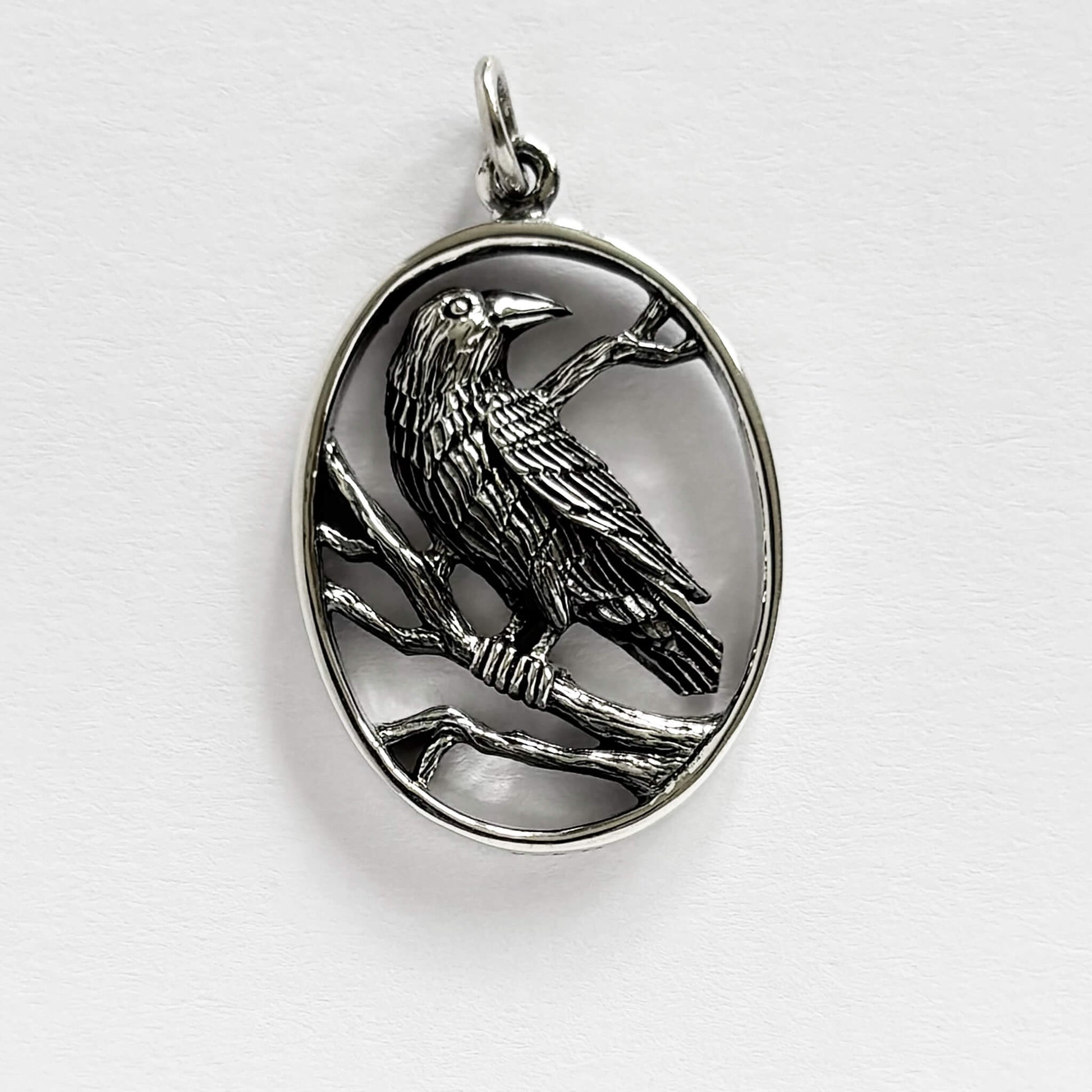 Crow in oval frame charm sterling silver raven bird pendant