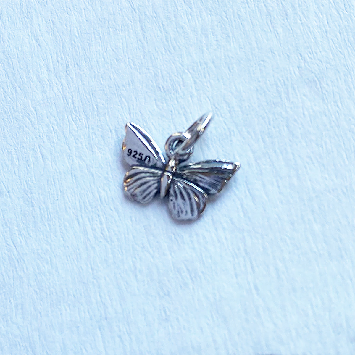 Tiny sterling silver butterfly charm at Charmarama