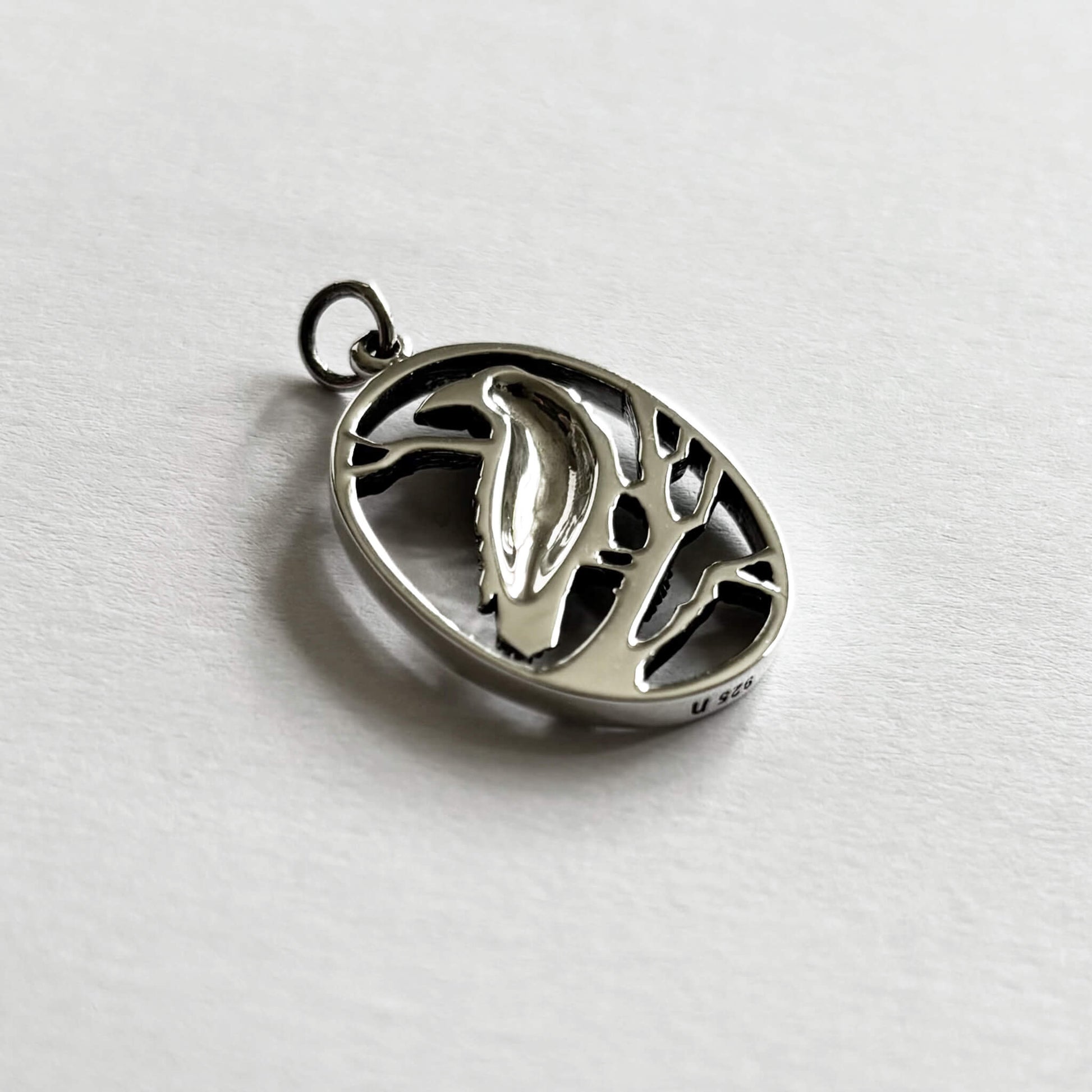 Crow in oval frame charm sterling silver bird pendant reverse