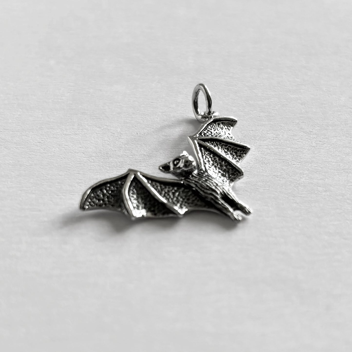 Sterling silver bat in flight charm pendant