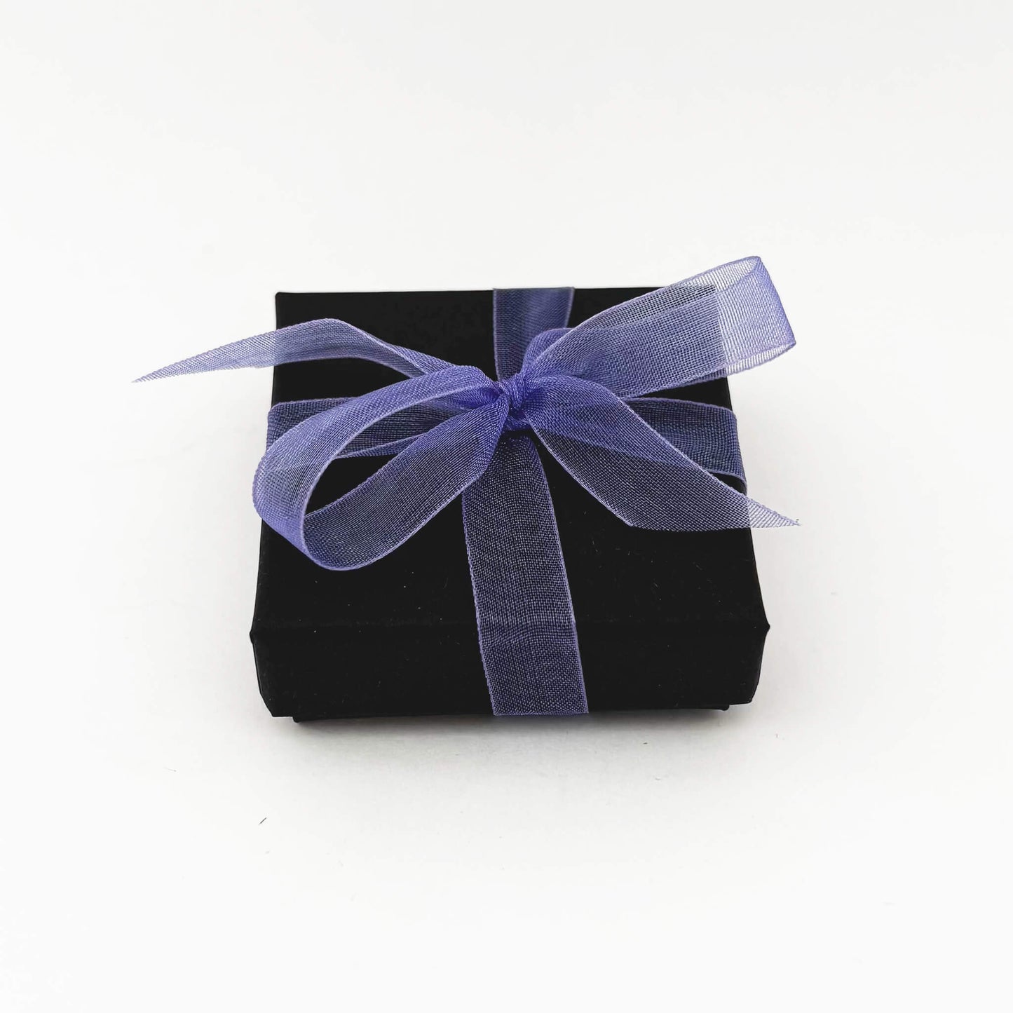 Black gift box with a purple ribbon on a white background
