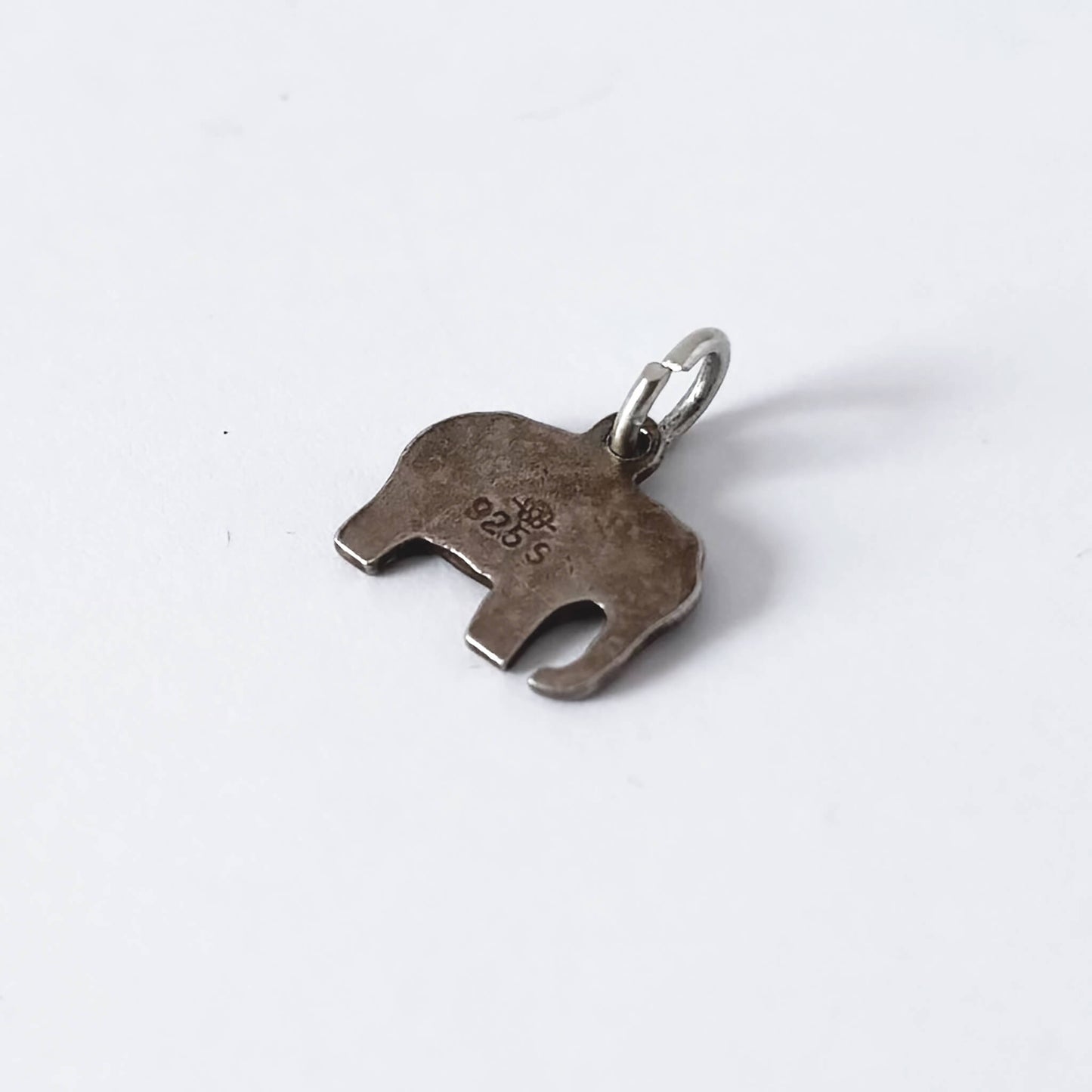 Silver elephant pendant on a white background