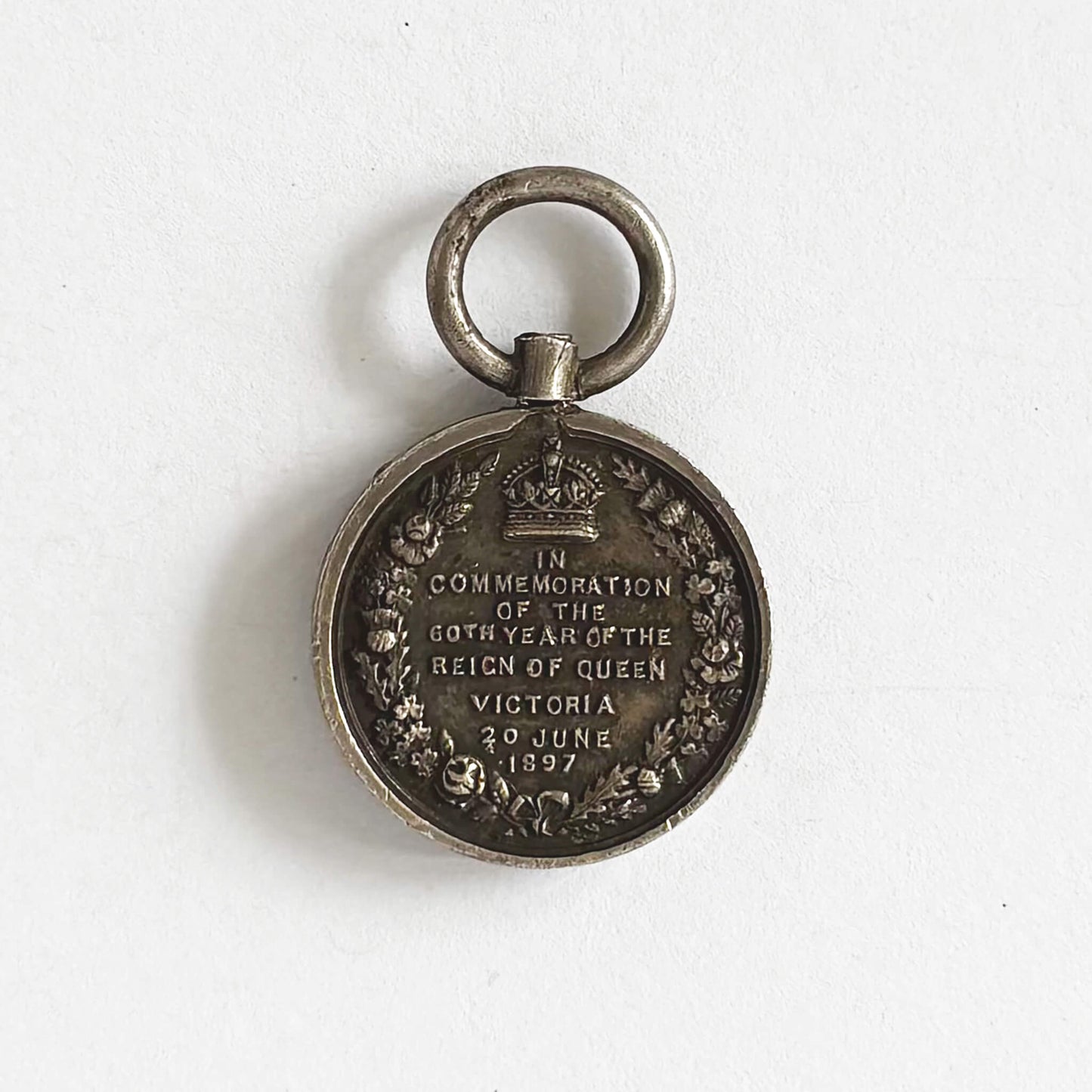 Medal commemorating the 60th year of Queen Victoria's reign on a white background