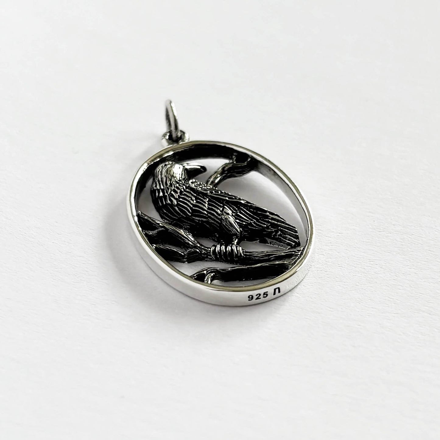 Raven in oval frame charm sterling silver bird pendant