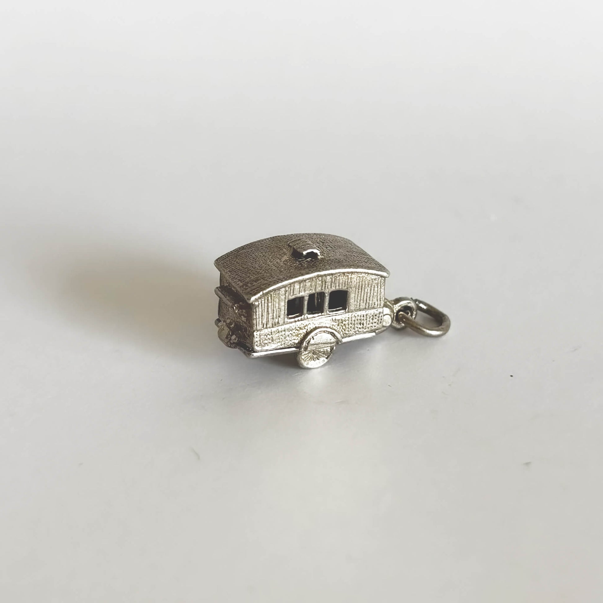 Silver caravan charm made in the 1970s opens to furniture