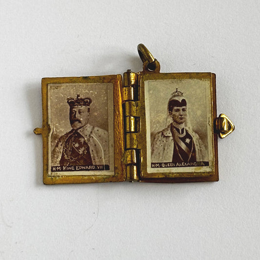 1902 Coronation photo album charm open to King Edward and Queen Alexandra on white background