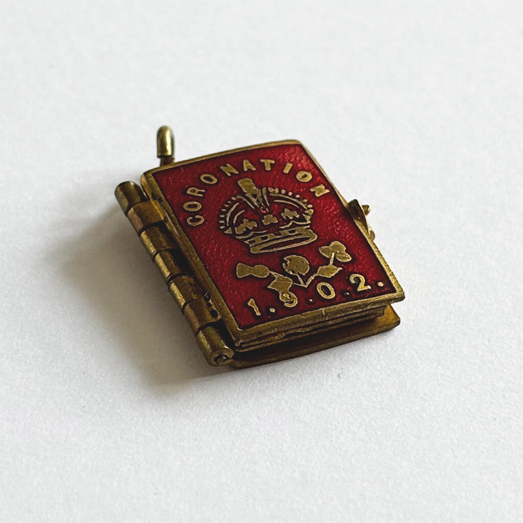1902 Coronation photo album closed and seen from side on white background