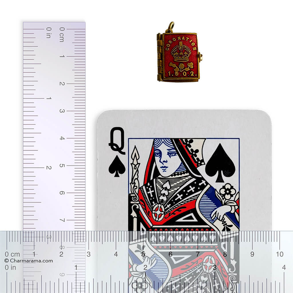 1902 Coronation photo album with playing card and ruler for scale on white background