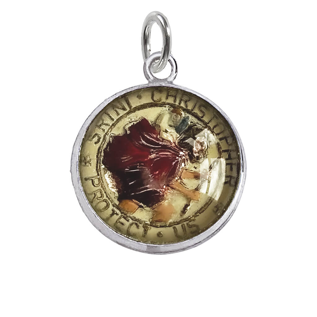 A vintage reverse crystal Saint Christopher charm on a white background