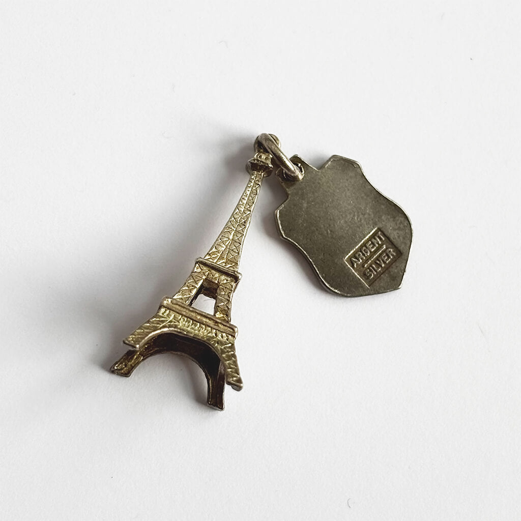 Pendant with Eiffel Tower and France travel shield on a white background