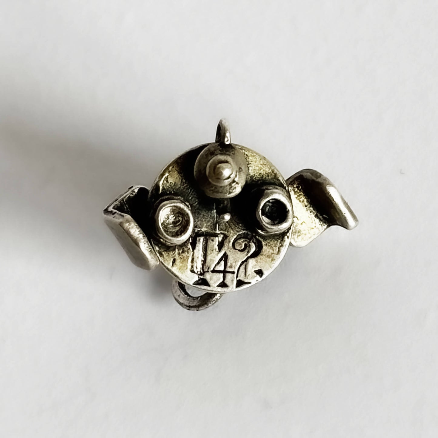 silver cafe table with teacups and teapot charm on a white background