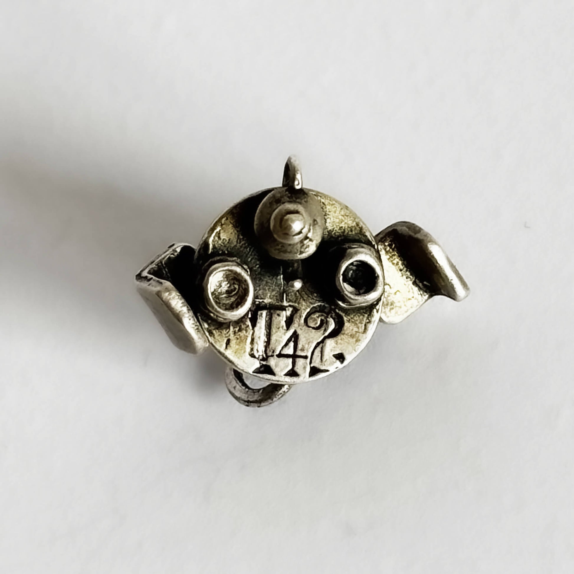 silver cafe table with teacups and teapot charm on a white background