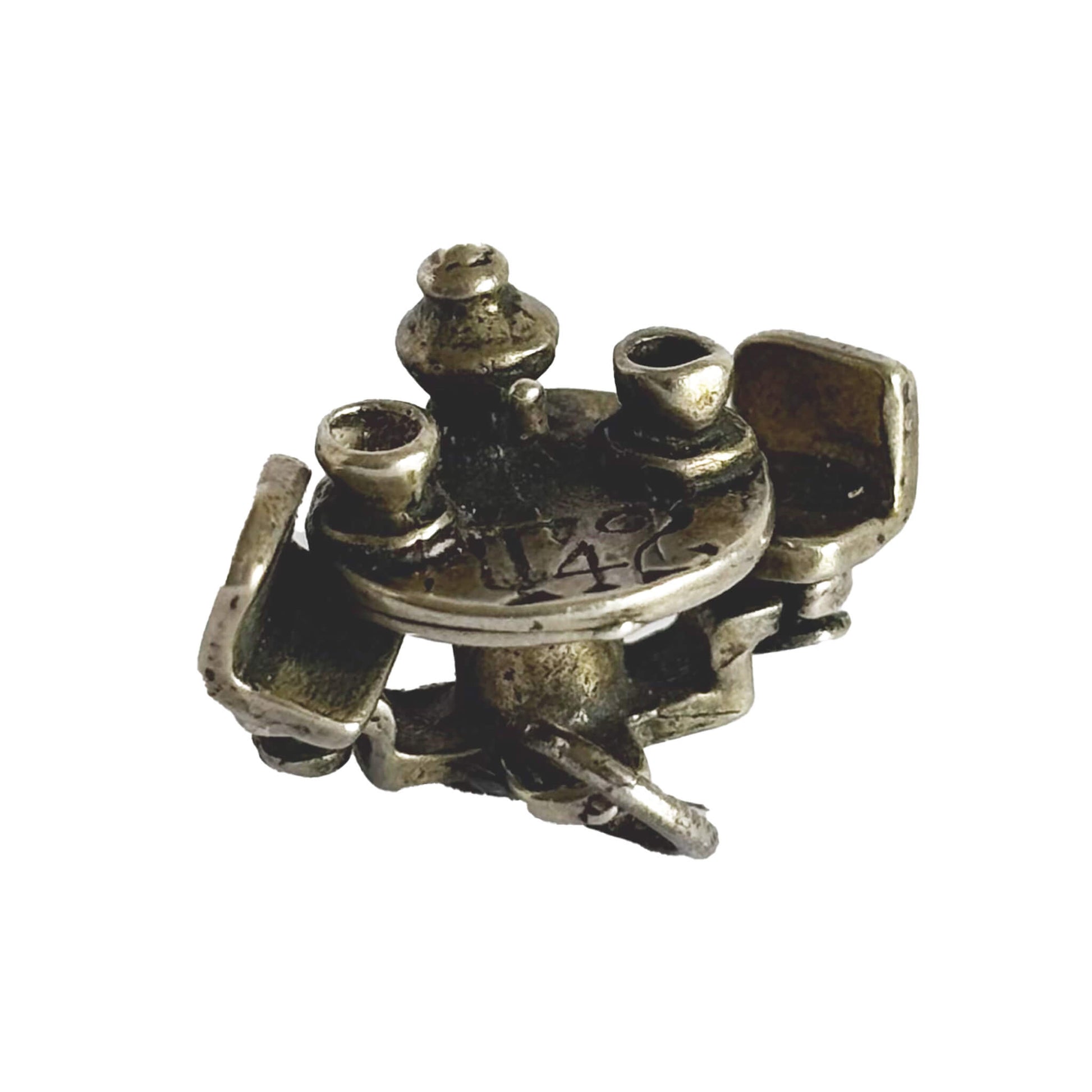 silver cafe table with teacups and teapot charm on a white background