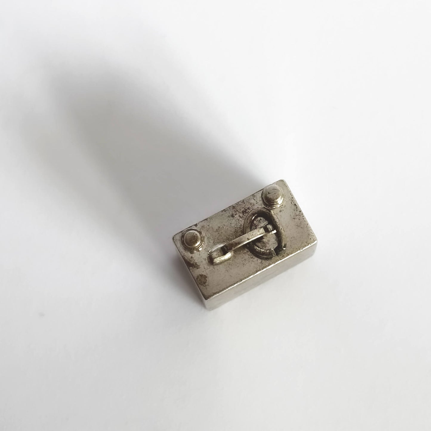 TV charm seen from top on a white background