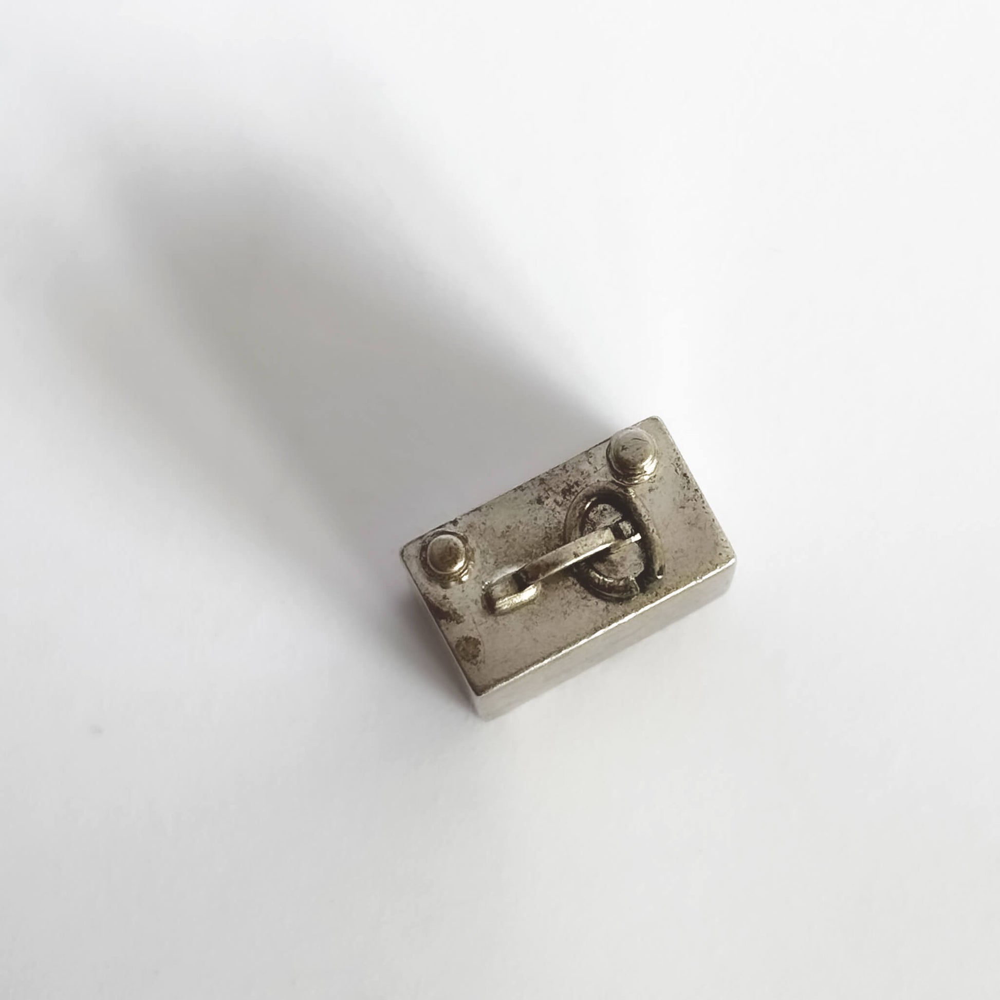 TV charm seen from top on a white background