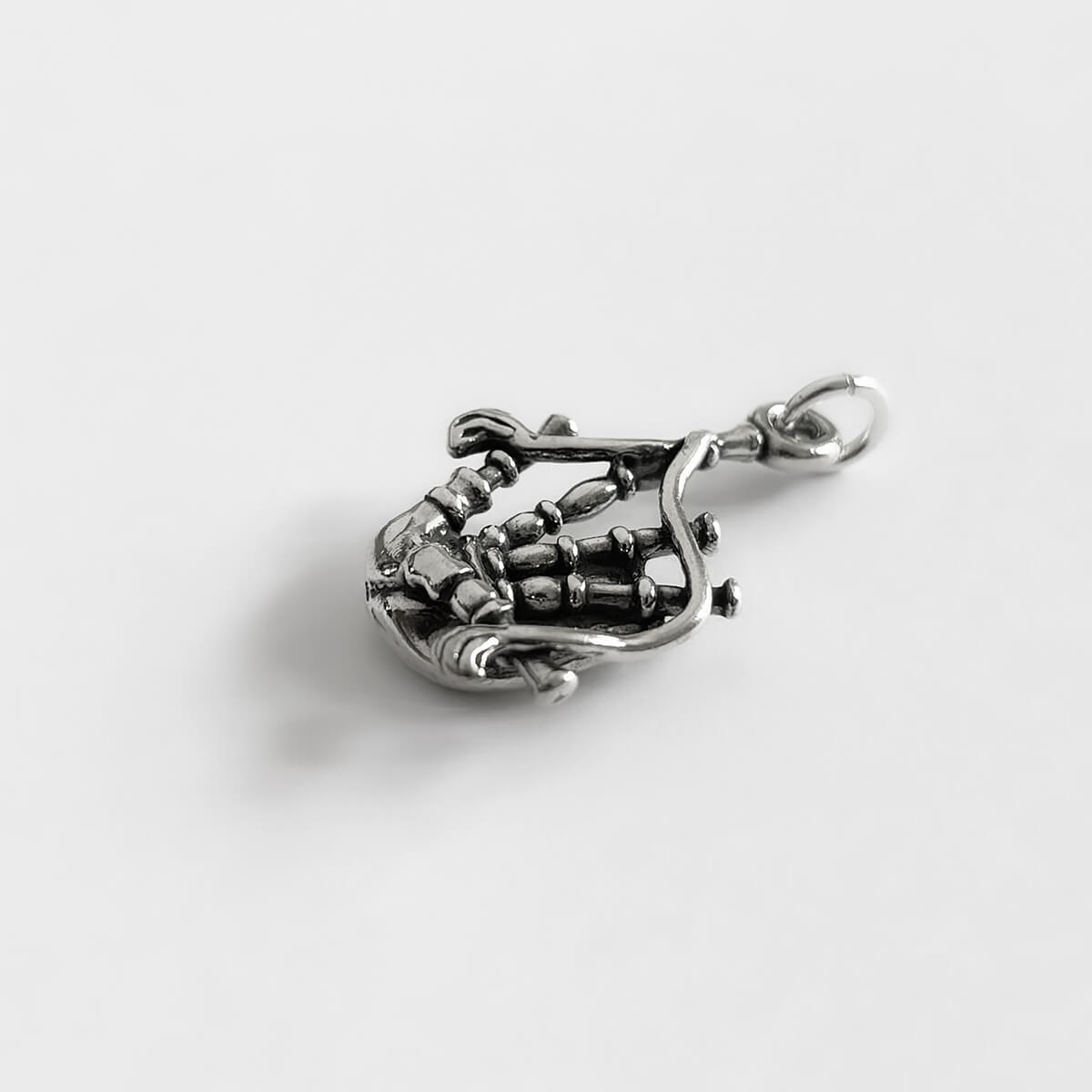 Sterling silver Scotch bagpipes charm side view on white background