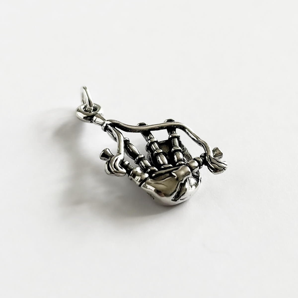 Sterling silver Scottish highlands bagpipes charm from Charmarama on a white background