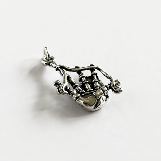 Sterling silver Scottish highlands bagpipes charm from Charmarama on a white background