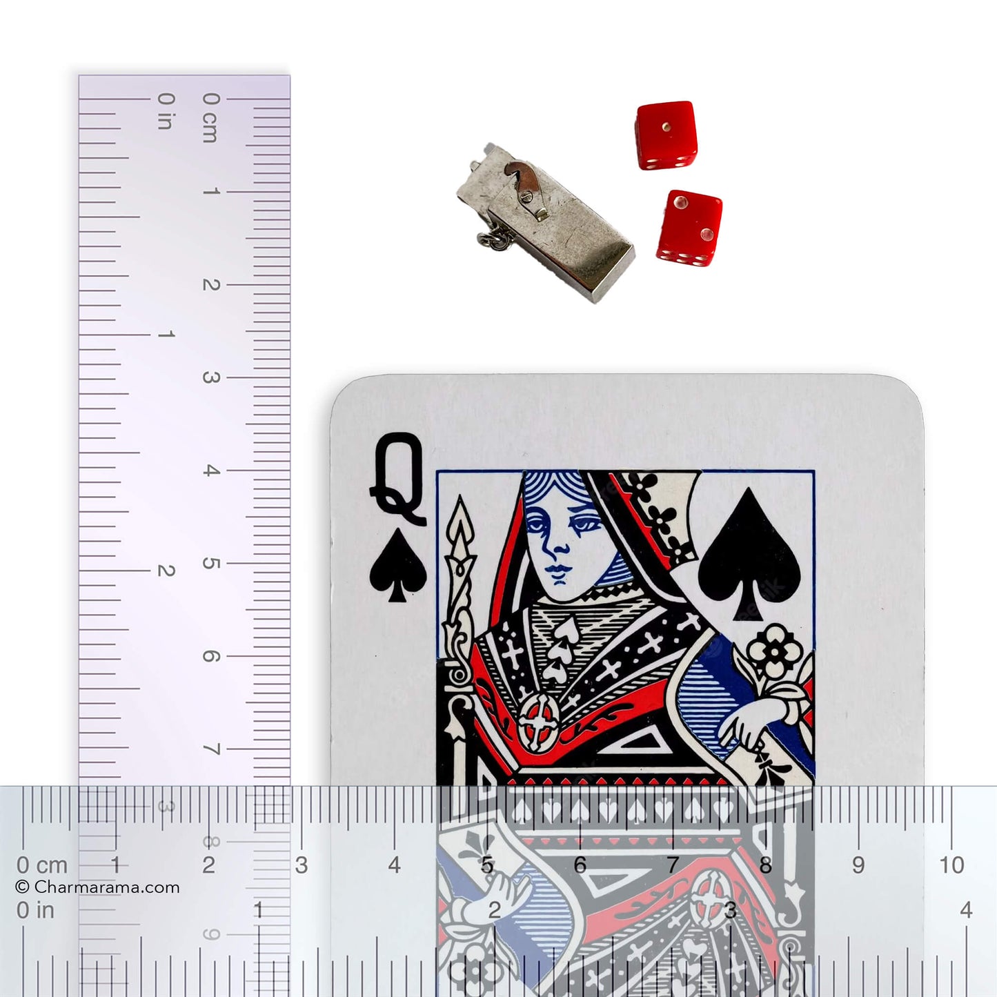 box and dice charm with playing card and ruler for scale on a white background.
