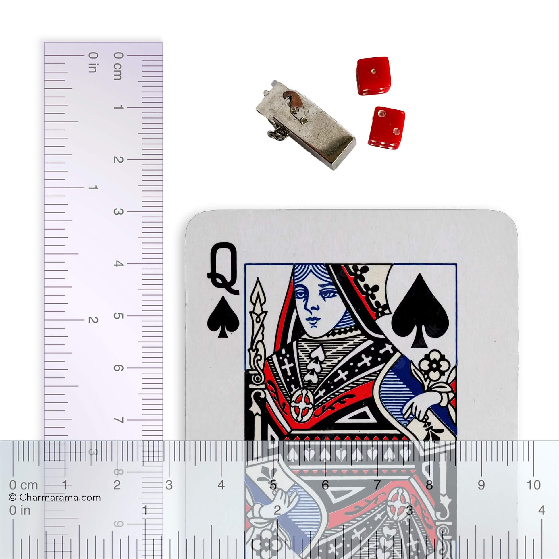 box and dice charm with playing card and ruler for scale on a white background.