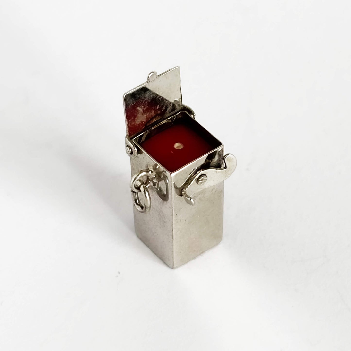 Red dice in sterling silver box charm on a white background